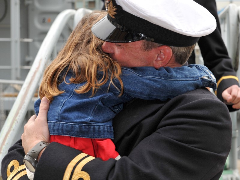 Armed Forces personnel hugging daughter