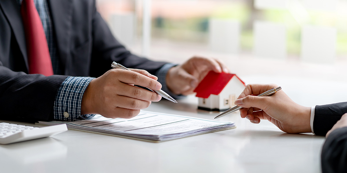 2 men discussing the deeds of a property