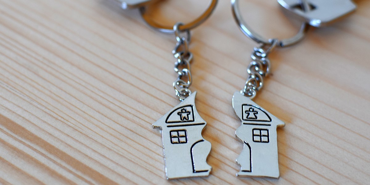 two keyrings with a side of a house each
