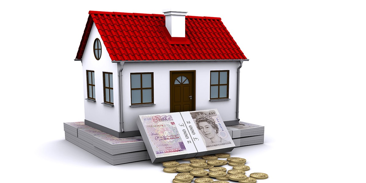 House with a bank note and coins in front of it
